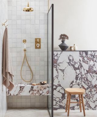 Wet room with porcelain white tiles and marble feature wall