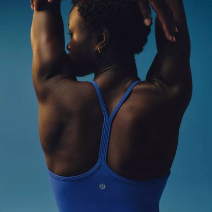 A model wearing a blue sports bra from Lululemon.