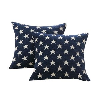 Two dark blue square throw pillows with white star patterns on them