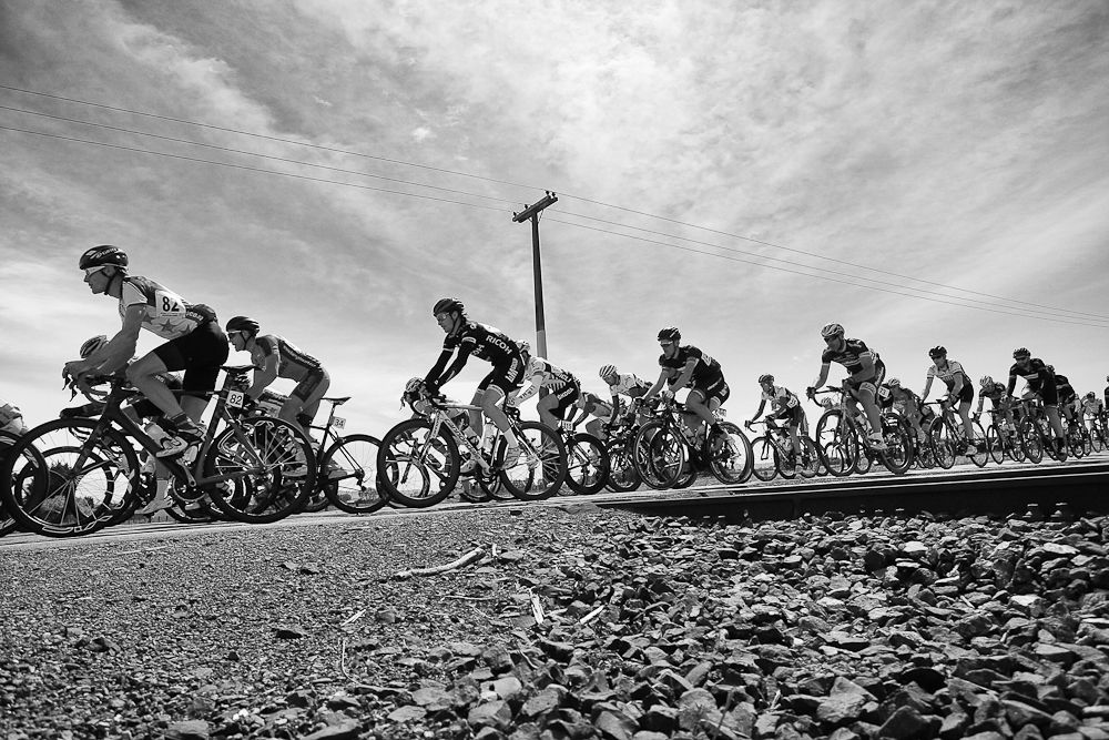 The main peloton passes over the Otautau railway in stage one of the Tour of Southland