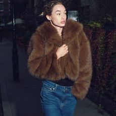 woman in faux fur coat and jeans