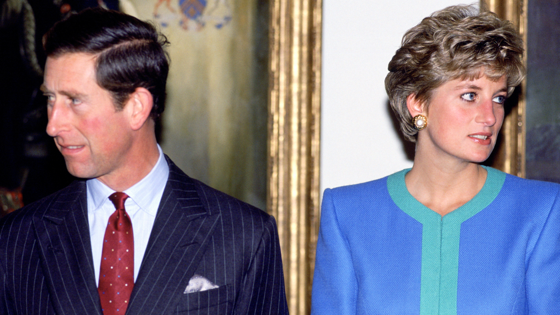 Princess Diana and Prince Charles looking away from each other with serious expressions