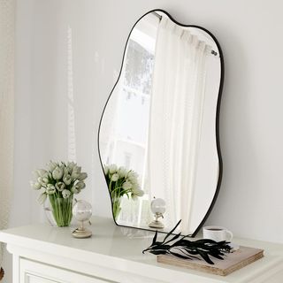 leaning vanity mirror with an irregular shape