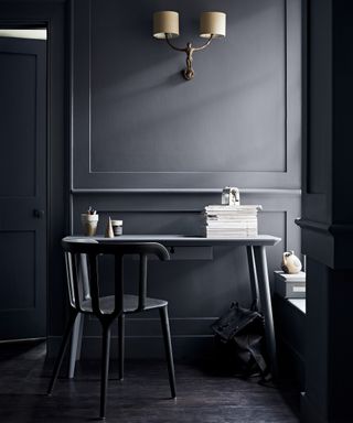 Crown home office idea in shade 'Aftershow' – an all black office with black walls, a small black desk, a black chair and a windowsill to the right