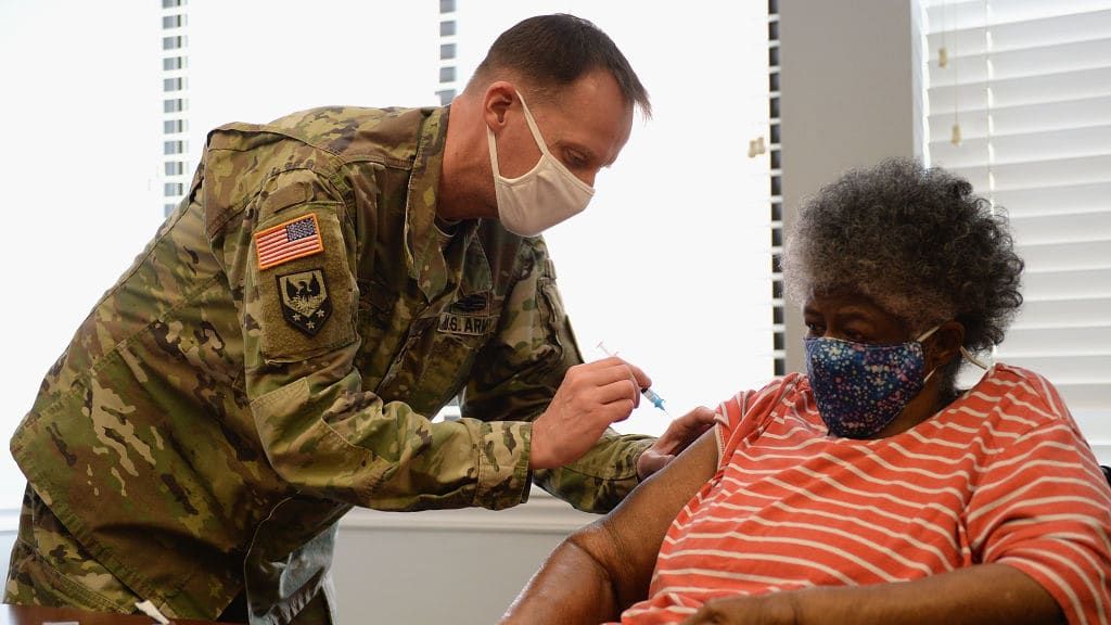 A woman in St. Louis gets the COVID-19 vaccine.