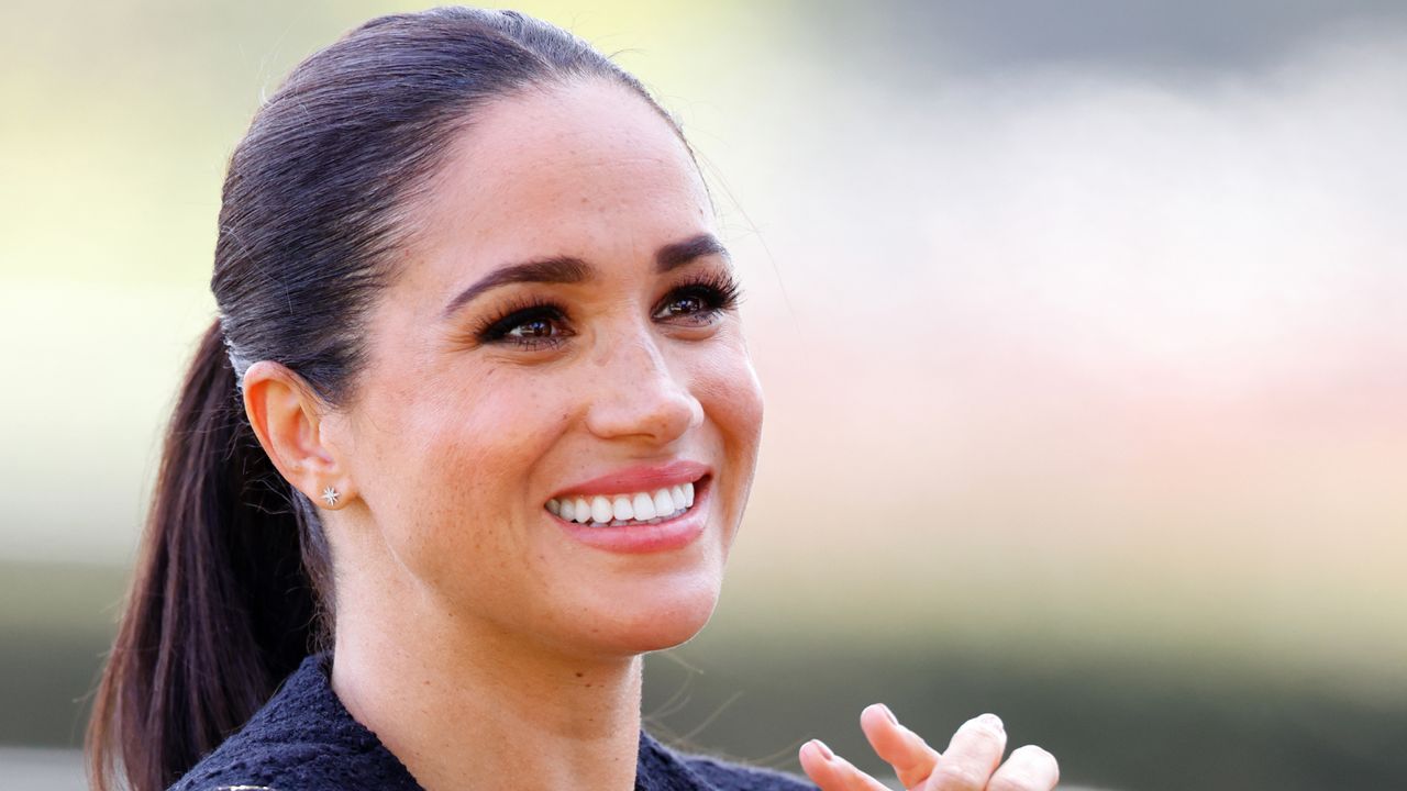 Meghan Markle at the Invictus Games wearing a collarless jacket and t-shirt