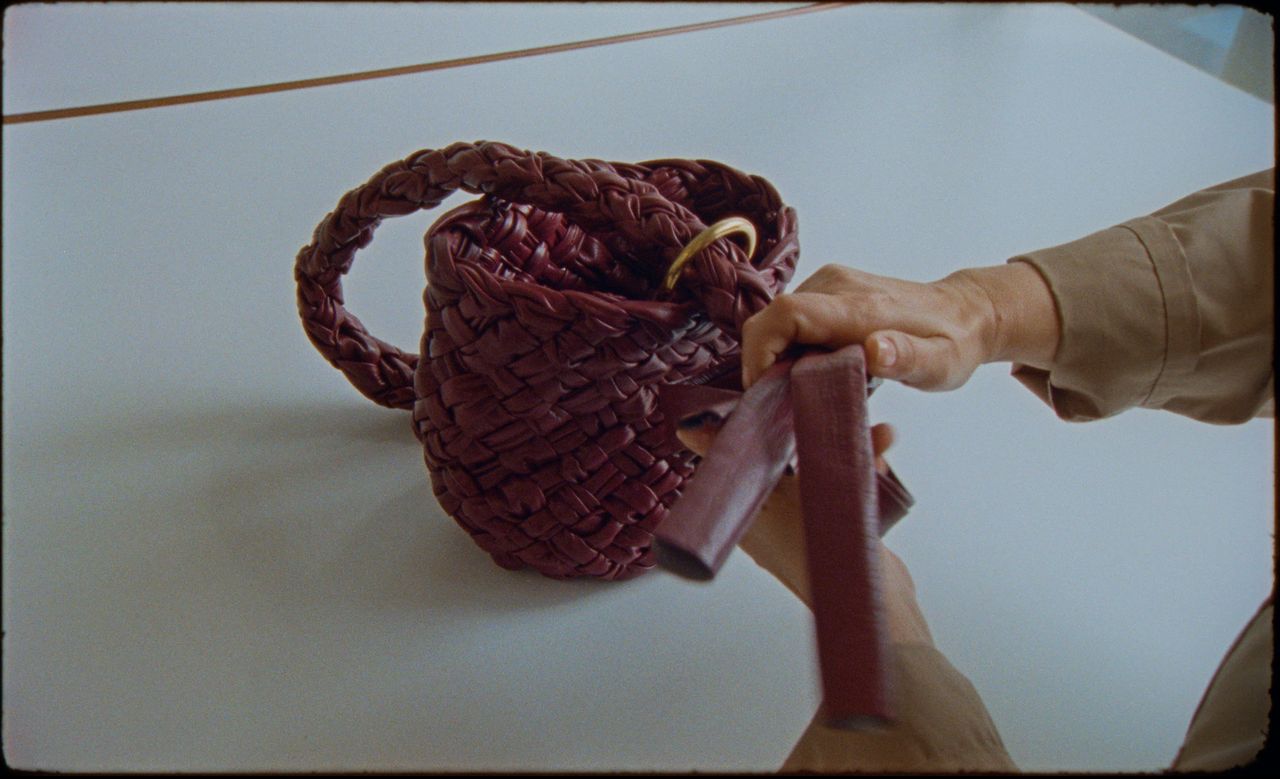 Somebody making a woven bottega veneta bag