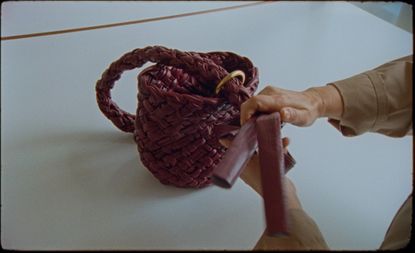 Somebody making a woven bottega veneta bag