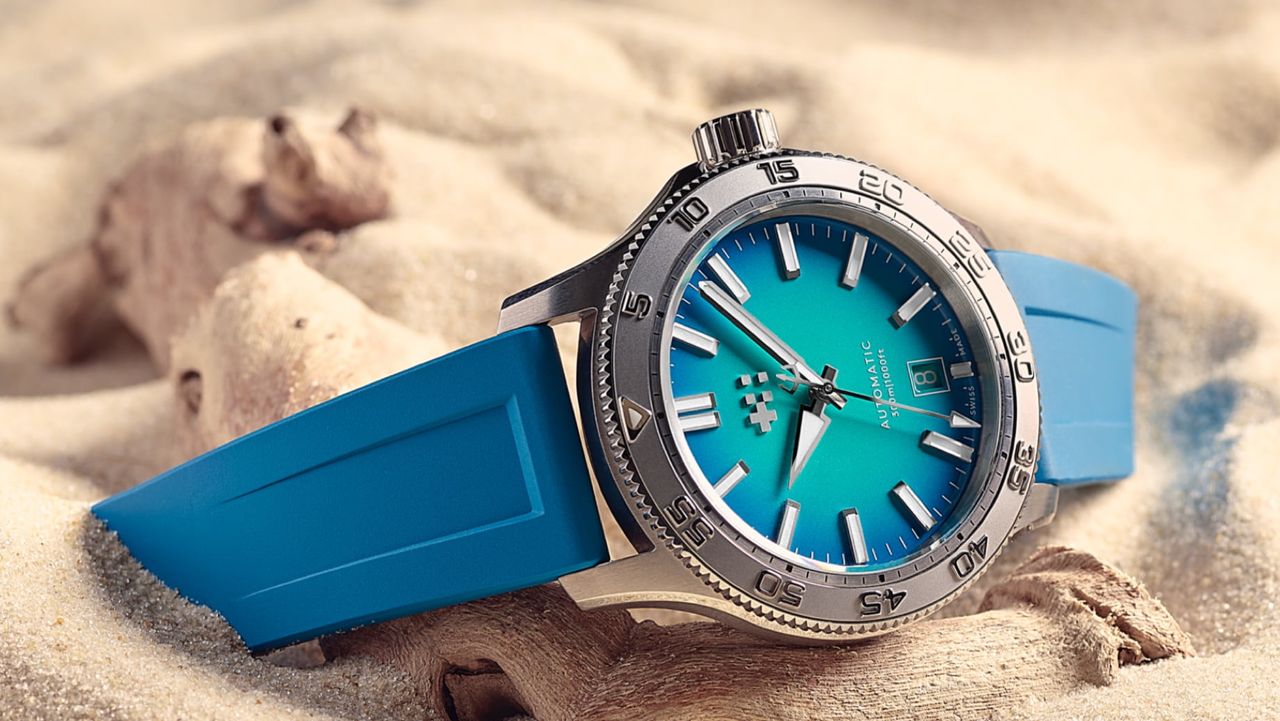 The Christopher Ward C60 Atoll 300 in blue, on a sandy beach