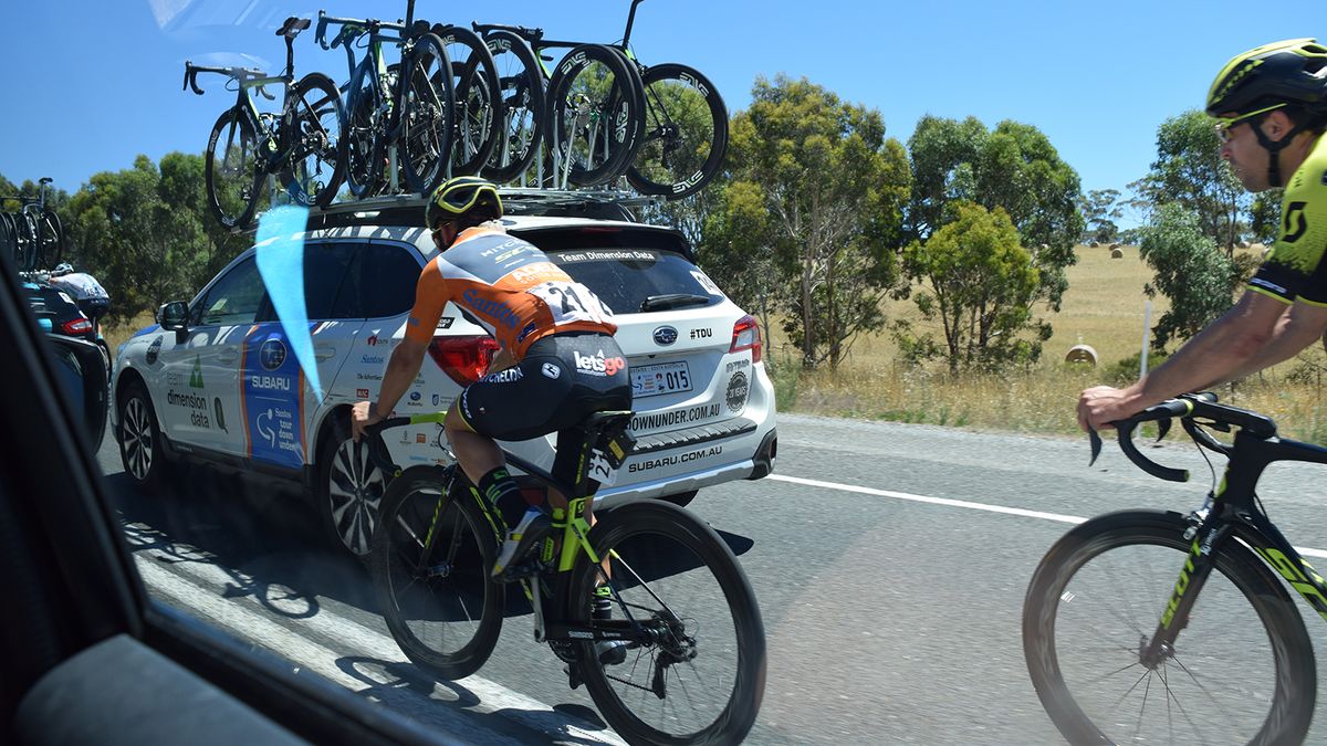 Current race leader Caleb Ewan (Mitchelton-Scott) is chaperoned back to the peloton by Jack Bauer