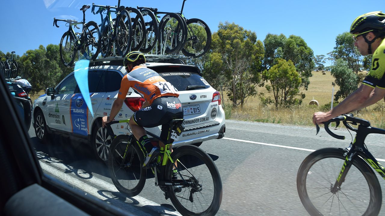 Current race leader Caleb Ewan (Mitchelton-Scott) is chaperoned back to the peloton by Jack Bauer