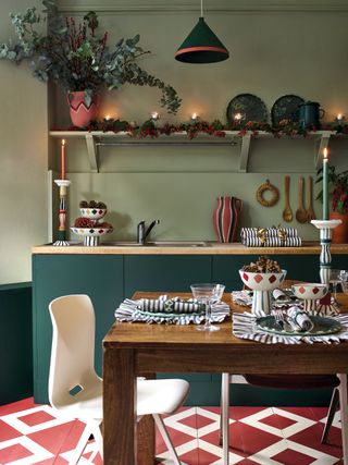 christmas kitchen with olive walls dark green cabinetry and red and white painted floor