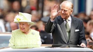 Queen Elizabeth II and Prince Philip, Duke of Edinburgh travel through Windsor in an open top Range Rover after her 90th Birthday Walkabout on April 21, 2016 in Windsor, England. Today is Queen Elizabeth II's 90th Birthday.