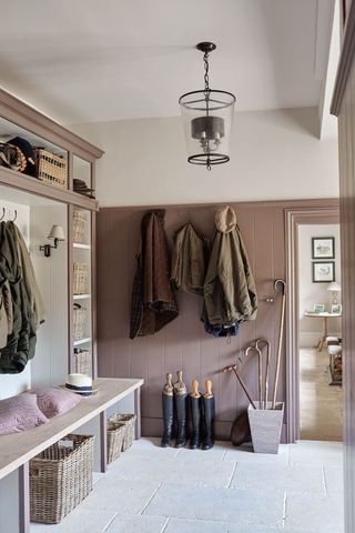 Mudroom design ideas with a grey stone floor complimented by a stylish pendant light, storage units and coat hooks