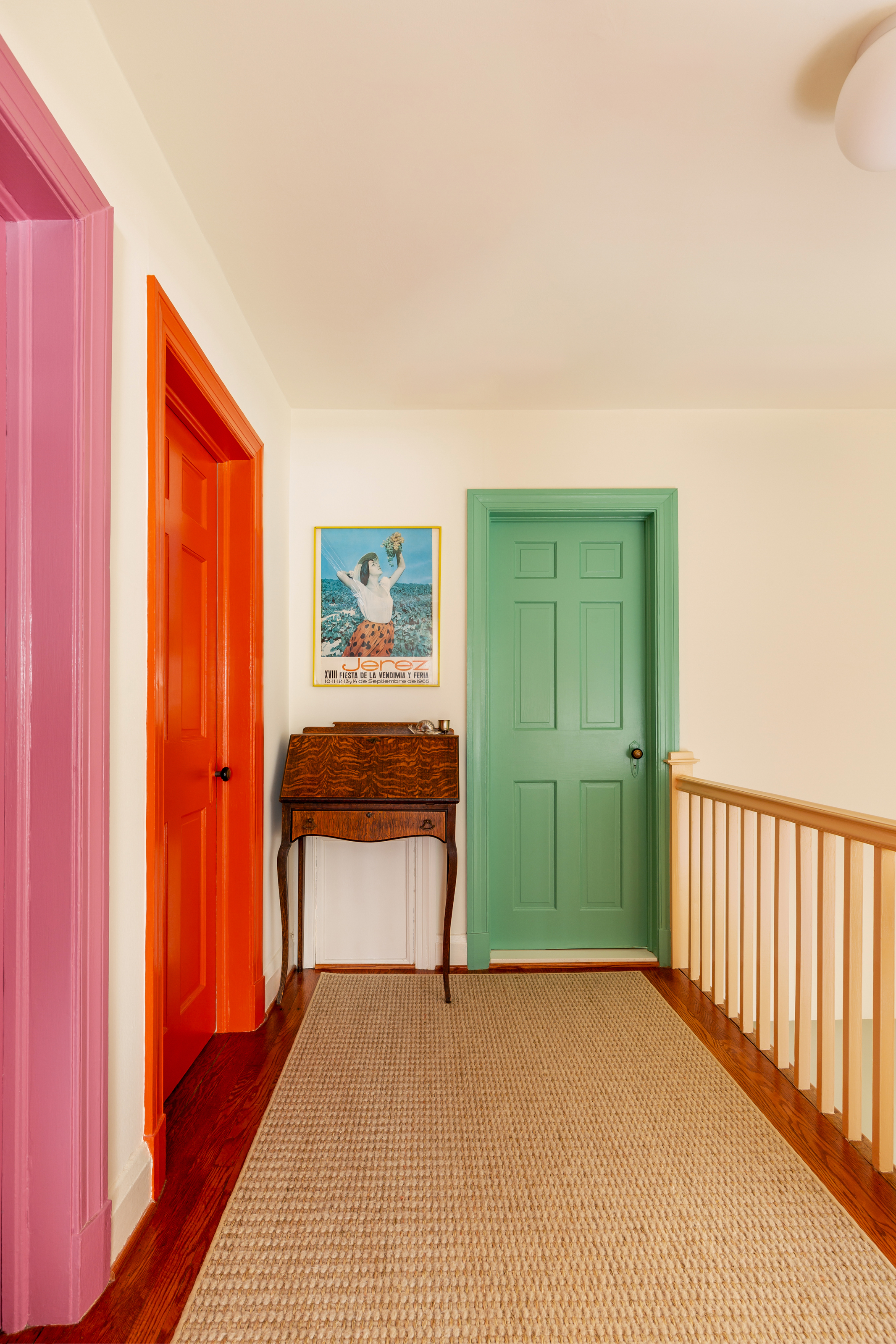 Hallway with doors painted in green, red and pink