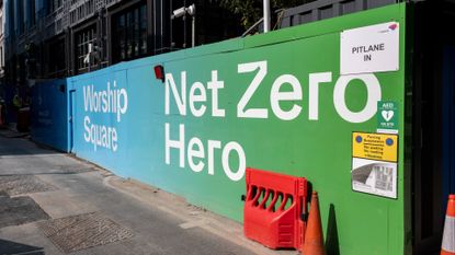 Hoarding around a construction site which reads Net Zero Hero on 26th September 2023 in London, United Kingdom