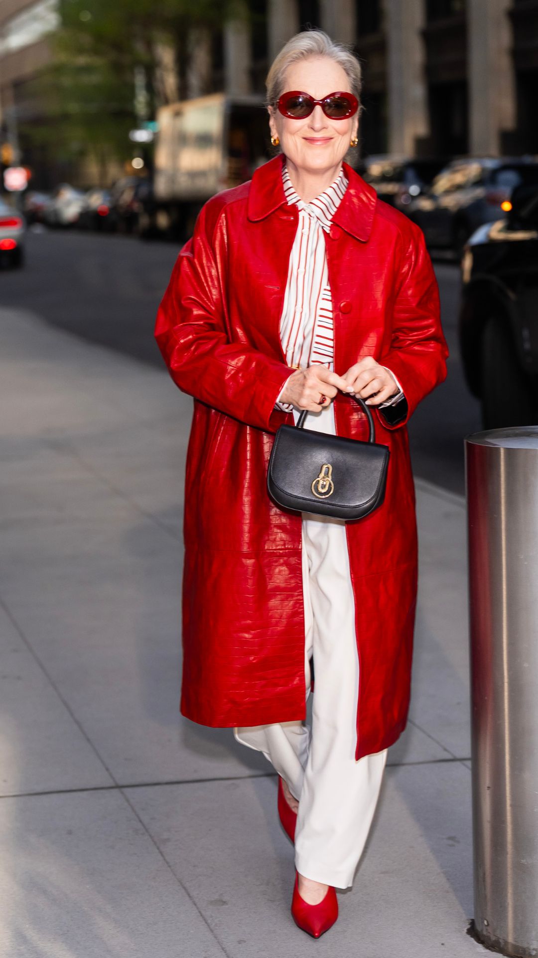 MERYL STREEP WEARING A RED AND WHITE OUTFIT WITH A MULBERRY BAG