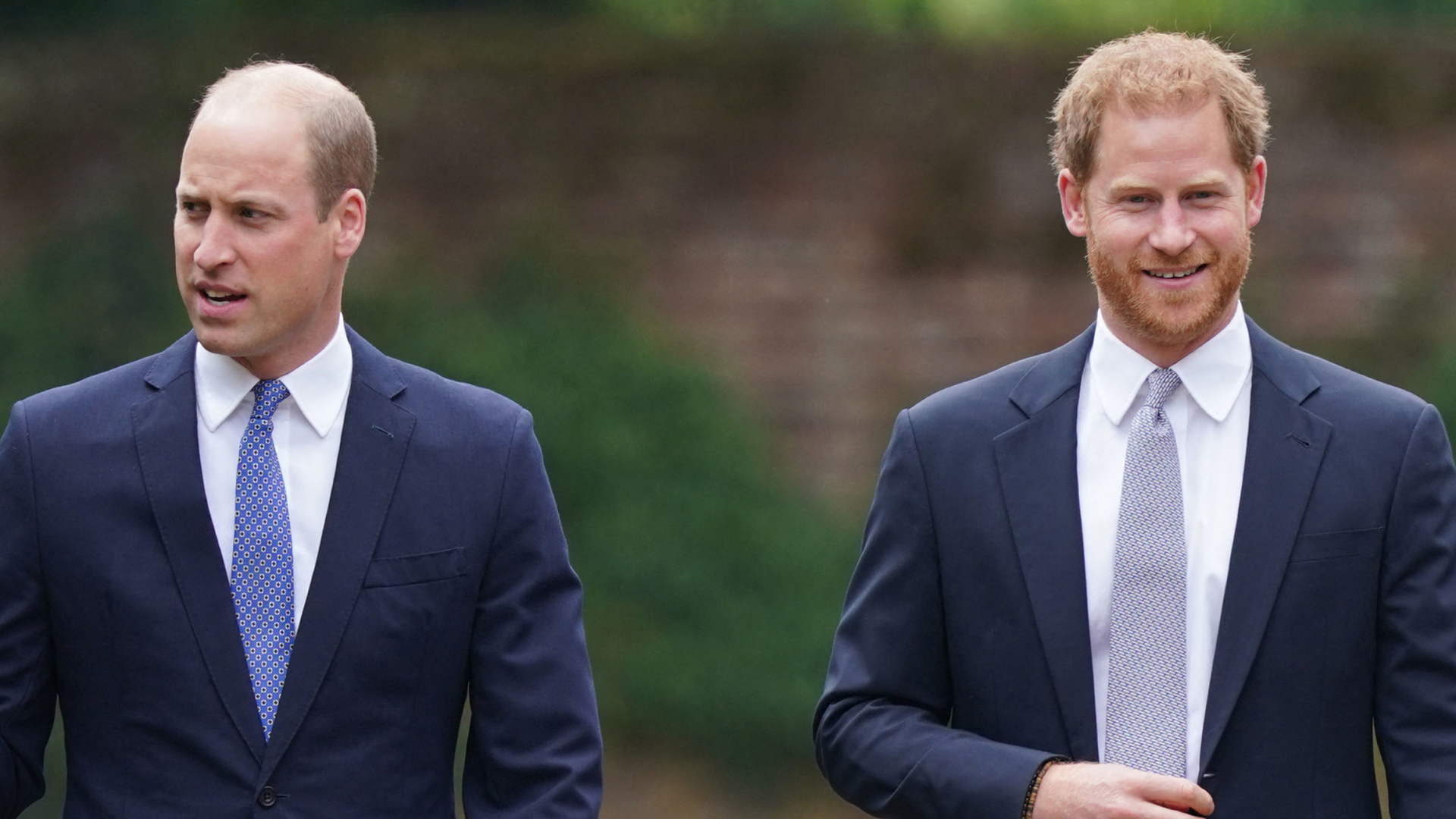 Prince William and Prince Harry both wearing suits, white shirts, and ties