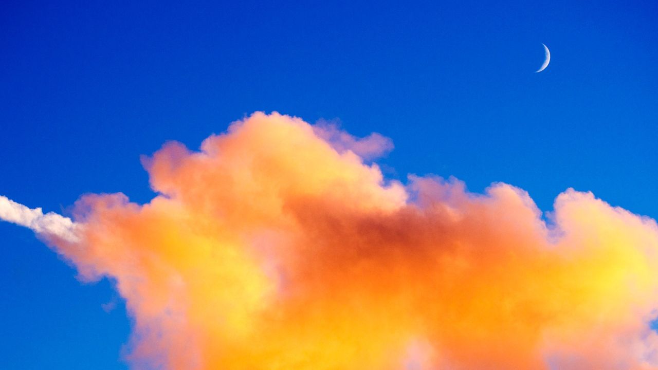 New Moon May 2022: Clouds and new moon at sunset over Padstow, Cornwall, UK. - stock photo