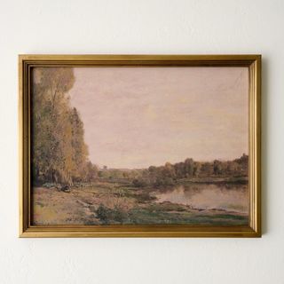 A landscape painting in a gold frame from Magnolia