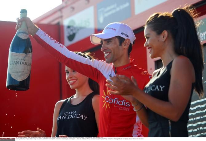 Dani Navarro (Cofidis) waves from the podium