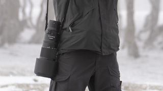 Photographer with the Nikkor Z 180-600mm lens by their side, outdoors wintry location