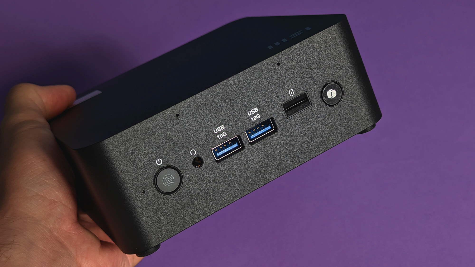 MSI Cubi NUC AI+ 2MG mini PC on a purple card stock background