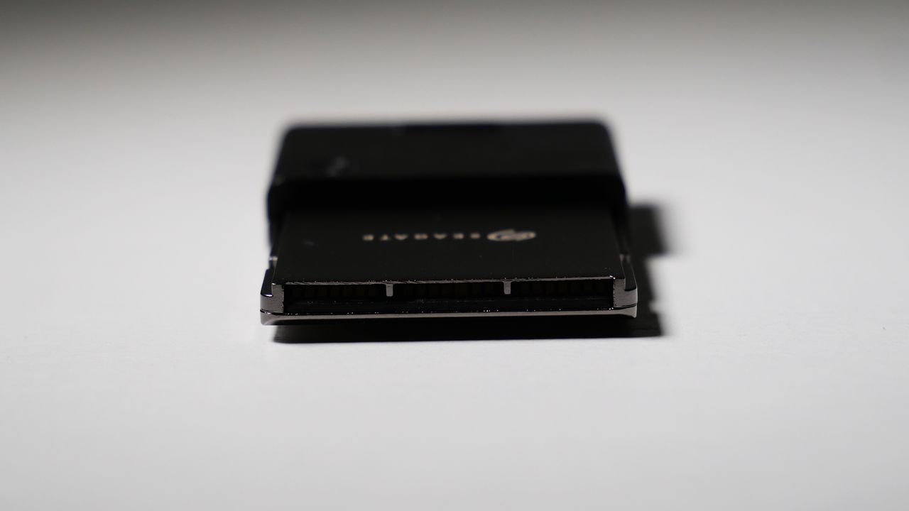 4TB Seagate Storage Expansion Card on a white desk, highlighting its light-and-thin design.