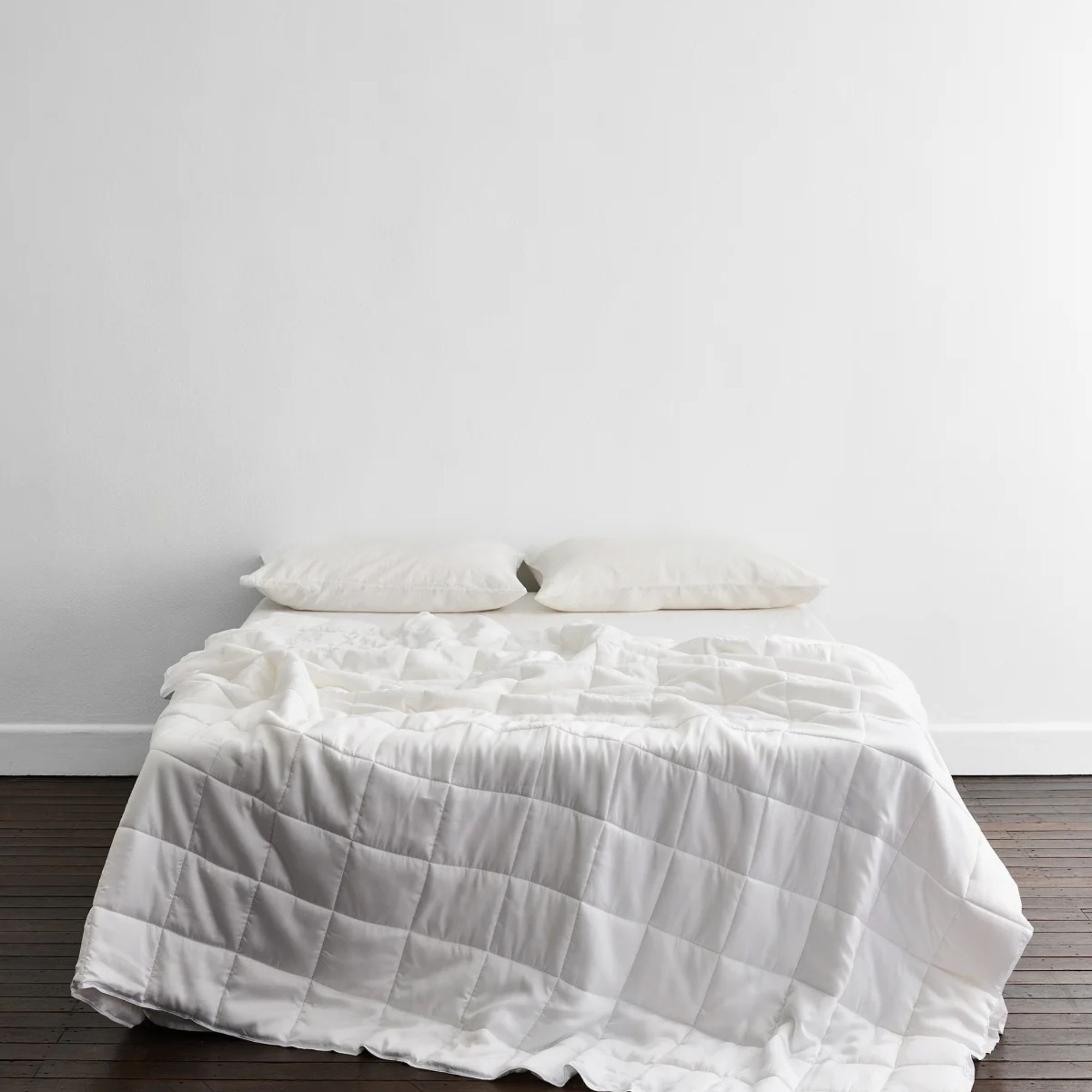Does-it-all Duvet Insert on a bed against a white wall. 