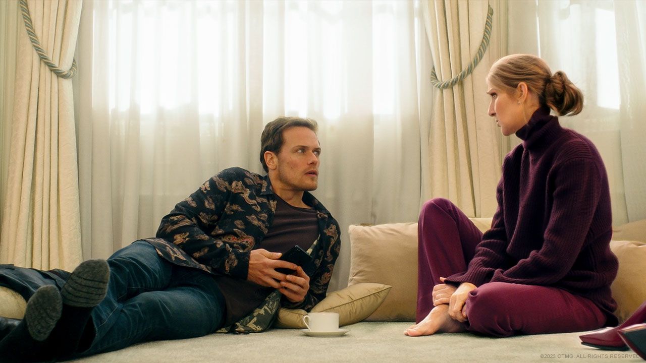 Sam Heughan and Celine Dion sit on the floor in Love Again