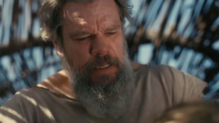 Screenshot of Matt Damon in a shelter with a full grown beard in The Odyssey 2026. 