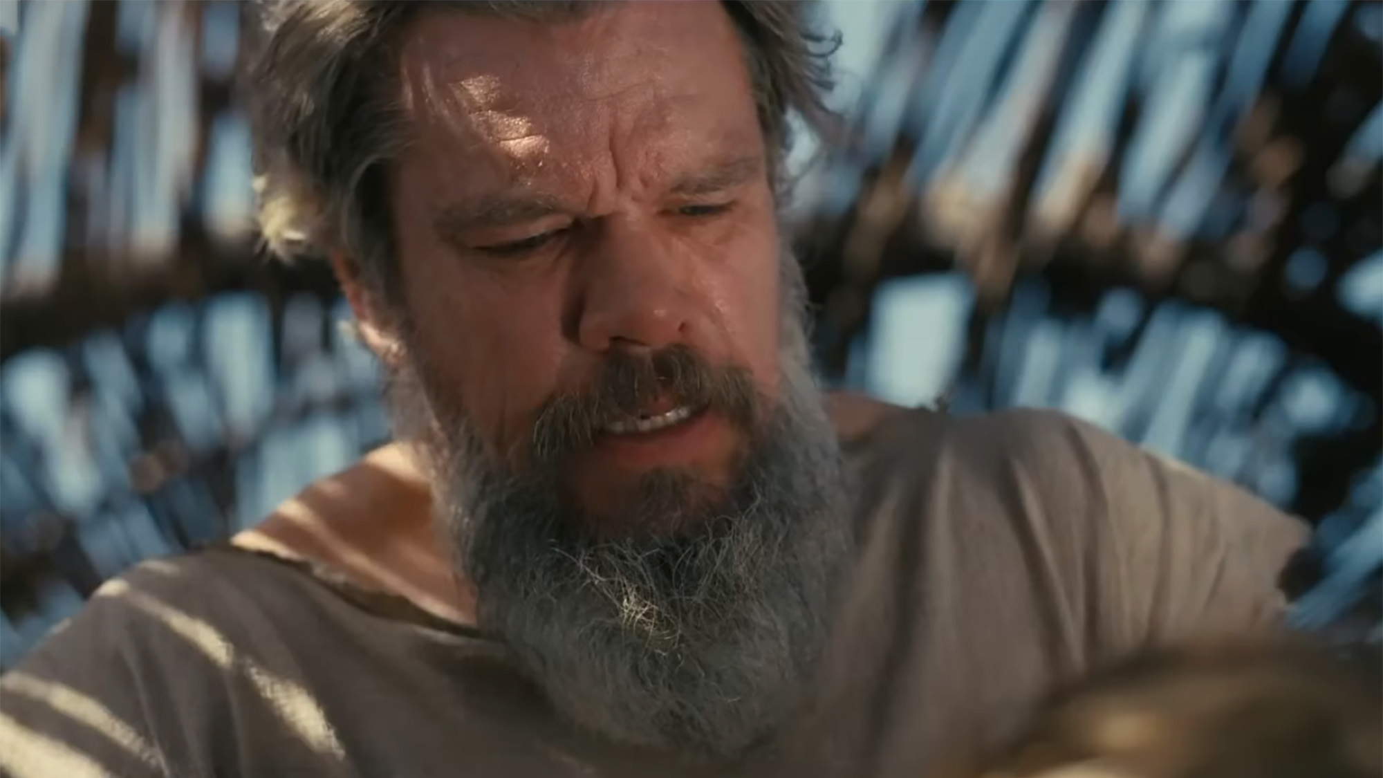 Screenshot of Matt Damon in a shelter with a full grown beard in The Odyssey 2026. 