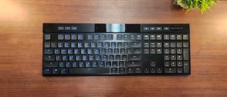 black low-profile keyboard against medium wood background