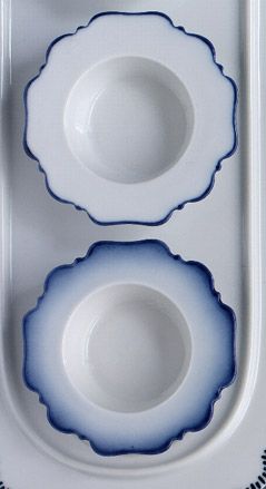 Two shaped bowls, white with blue edges