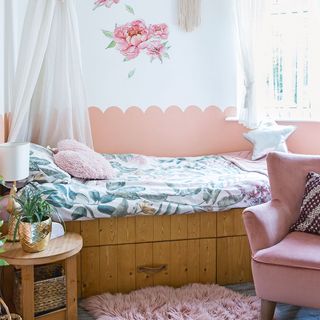 girls bedroom with pink painted scallop wall and bed canopy