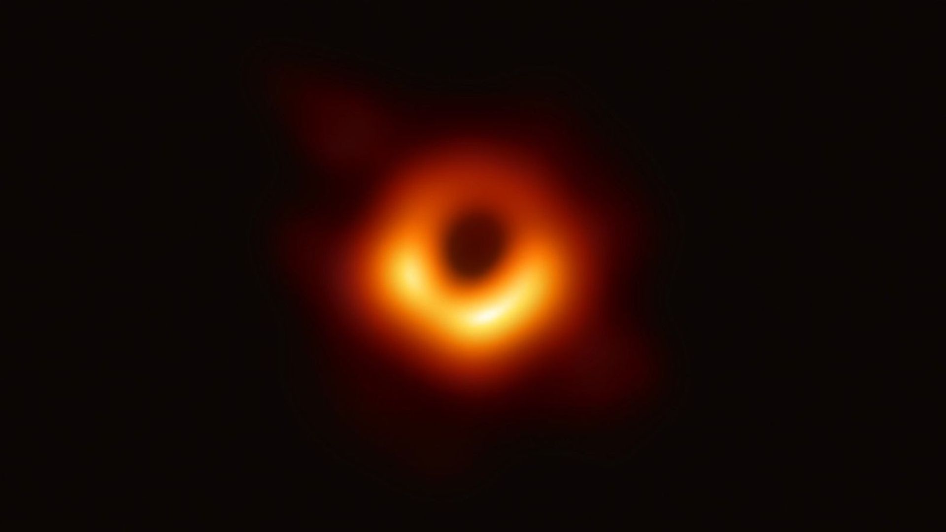 The first direct image of a black hole showing a blurry ring of orange around a central dark point