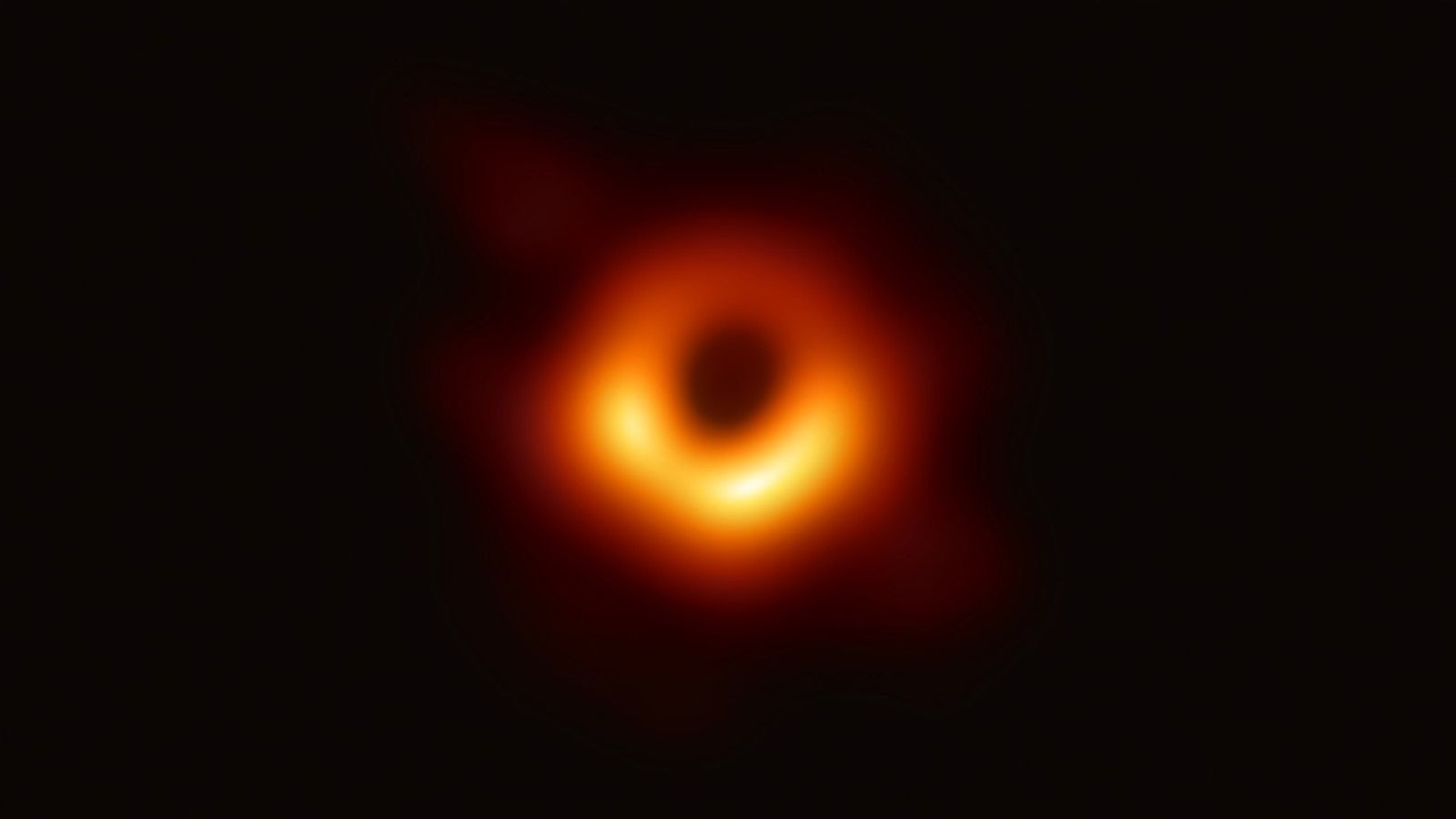 The first direct image of a black hole showing a blurry ring of orange around a central dark point