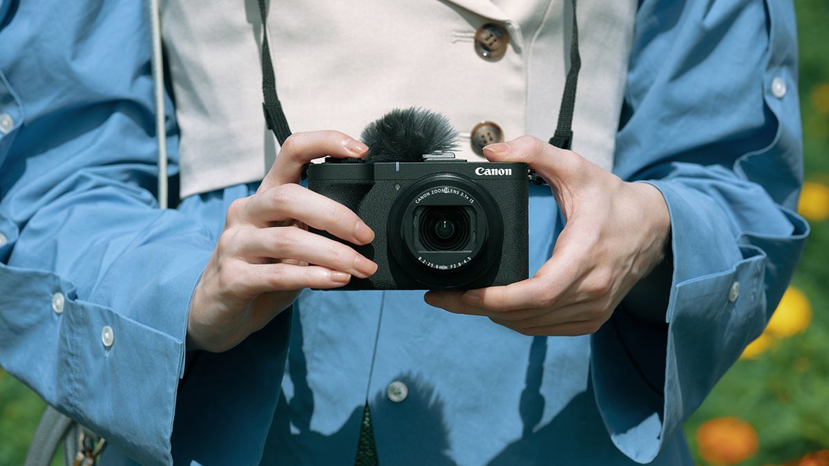 Canon PowerShot V1 being held by a vlogger outdoors