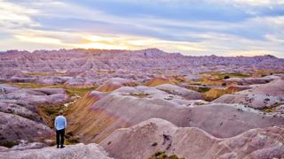 Young man watching sunset at Badlands National Park