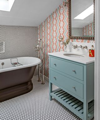 Small bathroom with circular tiles on floor and wall