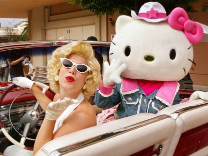 A woman dressed up like Marilyn Monroe with Hello Kitty.
