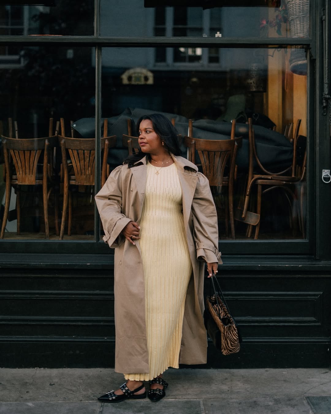 Karina in a butter yellow dress, flats and trench coat