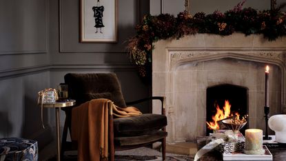 Dark Christmas living room scheme with garland over mantlepiece