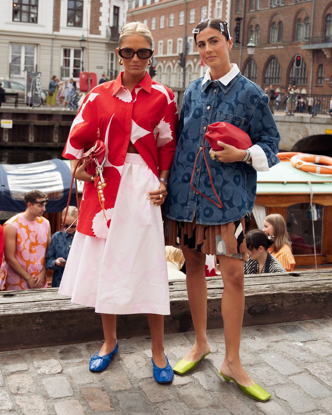 two street style stars in copenhagen wearing bold bright patterned clothes