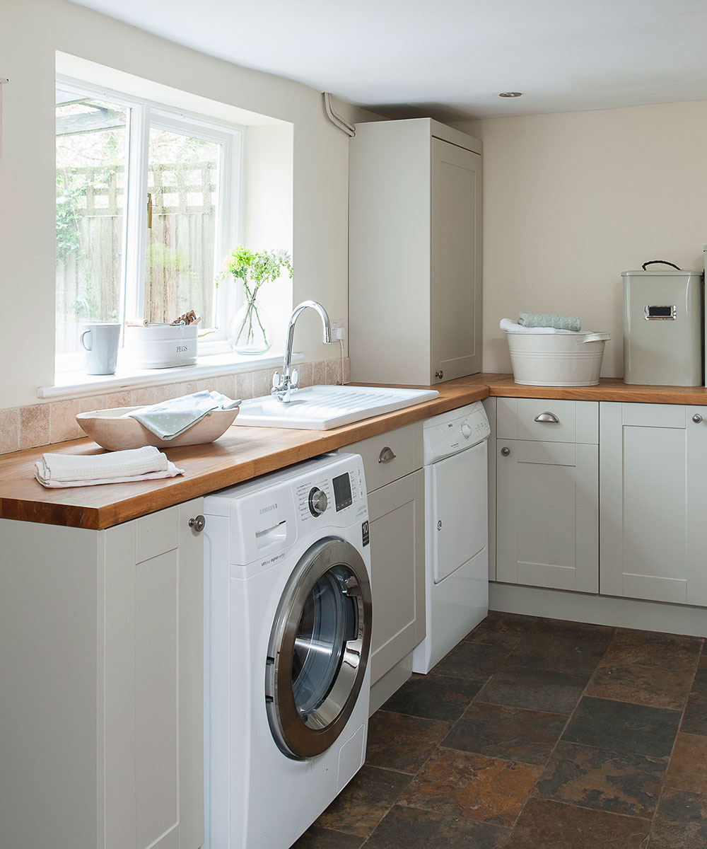 Neutral utility room with wooden work surfaces
