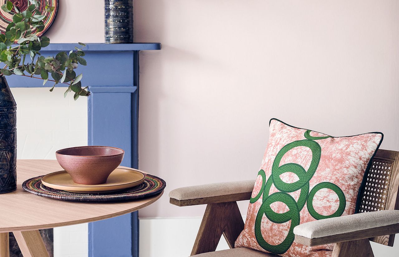 living room with pink walls and blue fireplace