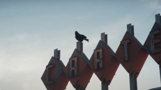 A crow perched on a building sign in Agatha All Along