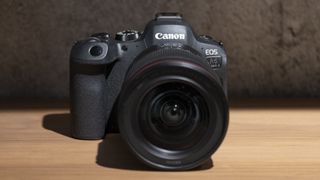 The Canon EOS R6 Mark II camera on a wooden shelf