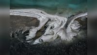Colorful patterns in landscape produced by industrial mineral extraction. 