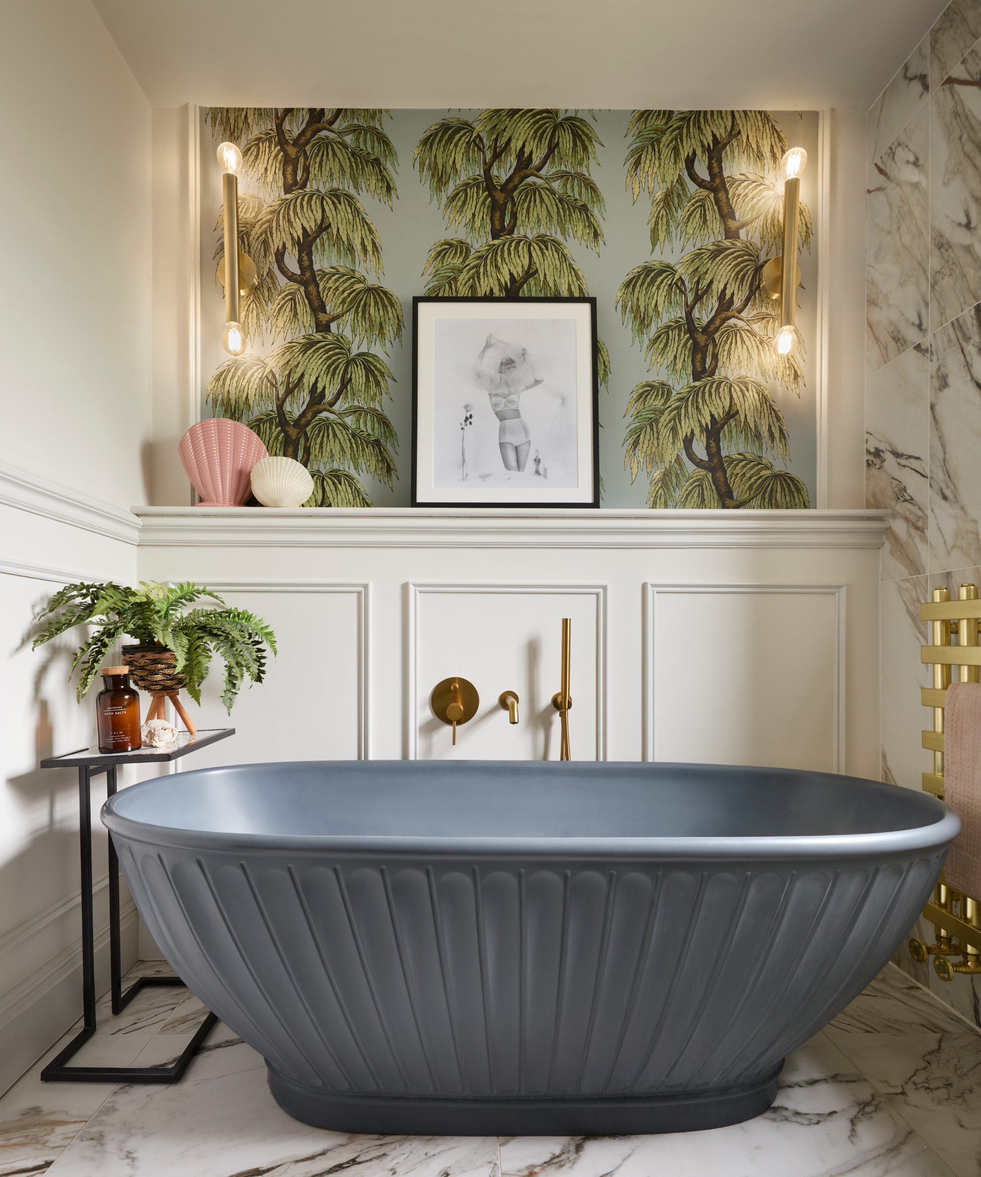 grey freestanding bath with fluted design in bathroom with wall panelling and wallpaper